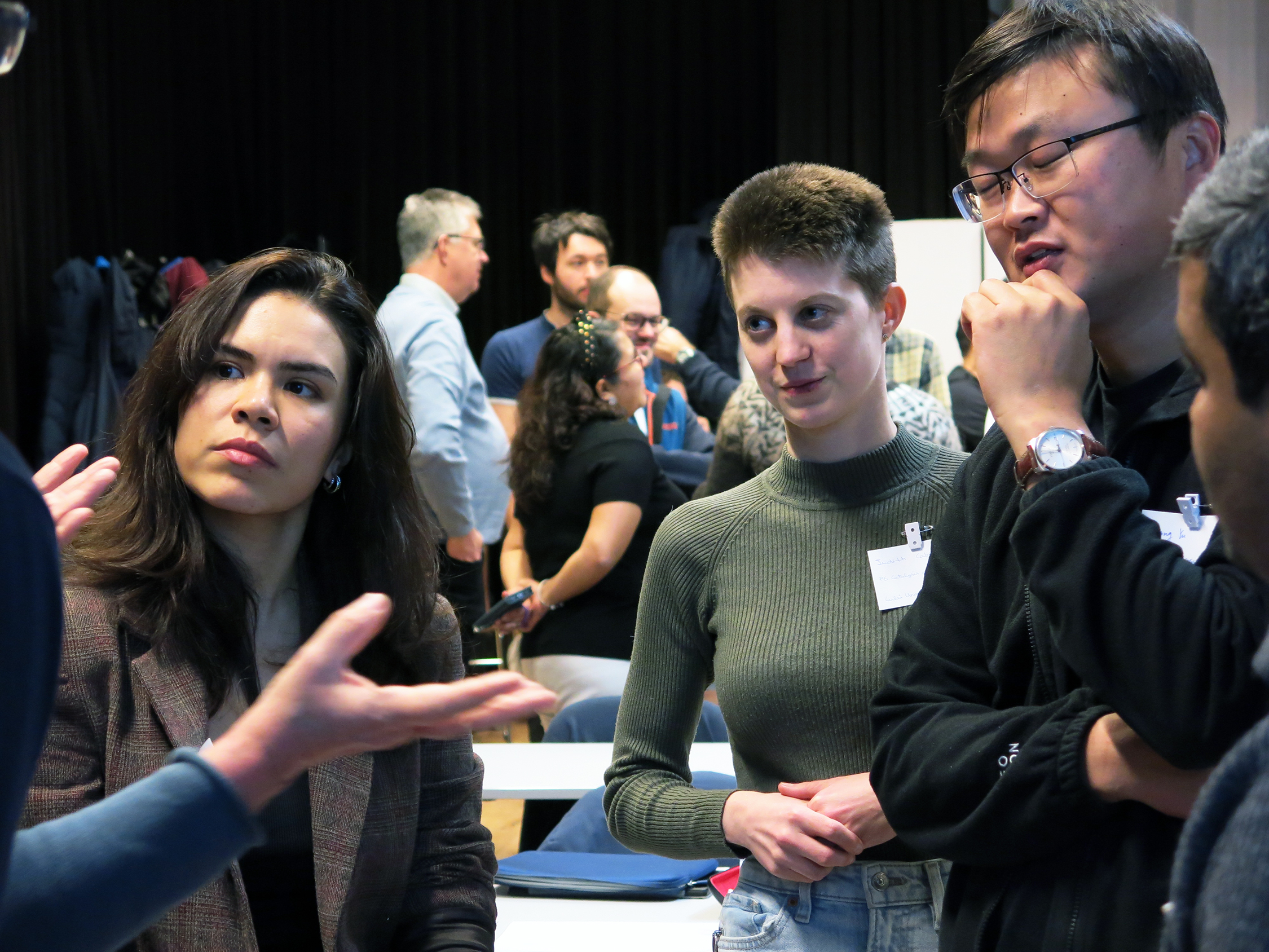 Iliana, Judith, Liang and Santosh in discussion during a research poster session. Photo by Anna Strom ©2023.